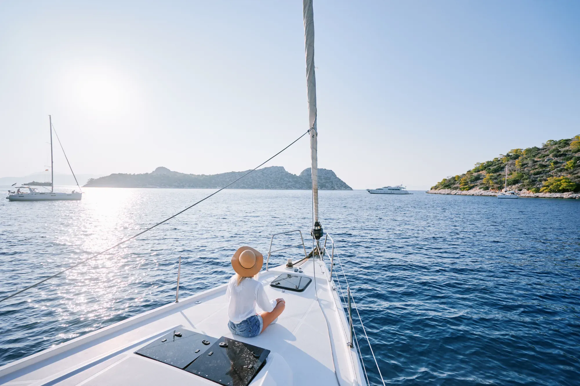young happy woman on boat deck sailing the sea